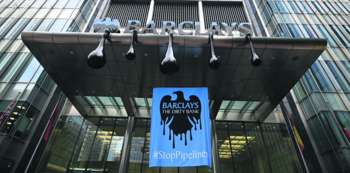Dirty bank banner hung at Barclays HQ entrance by Greenpeace