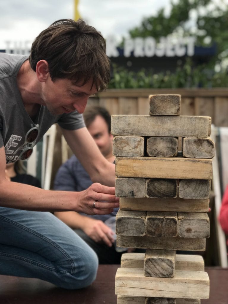 Managing Director Tom Greenwood playing jenga with the team on the team day