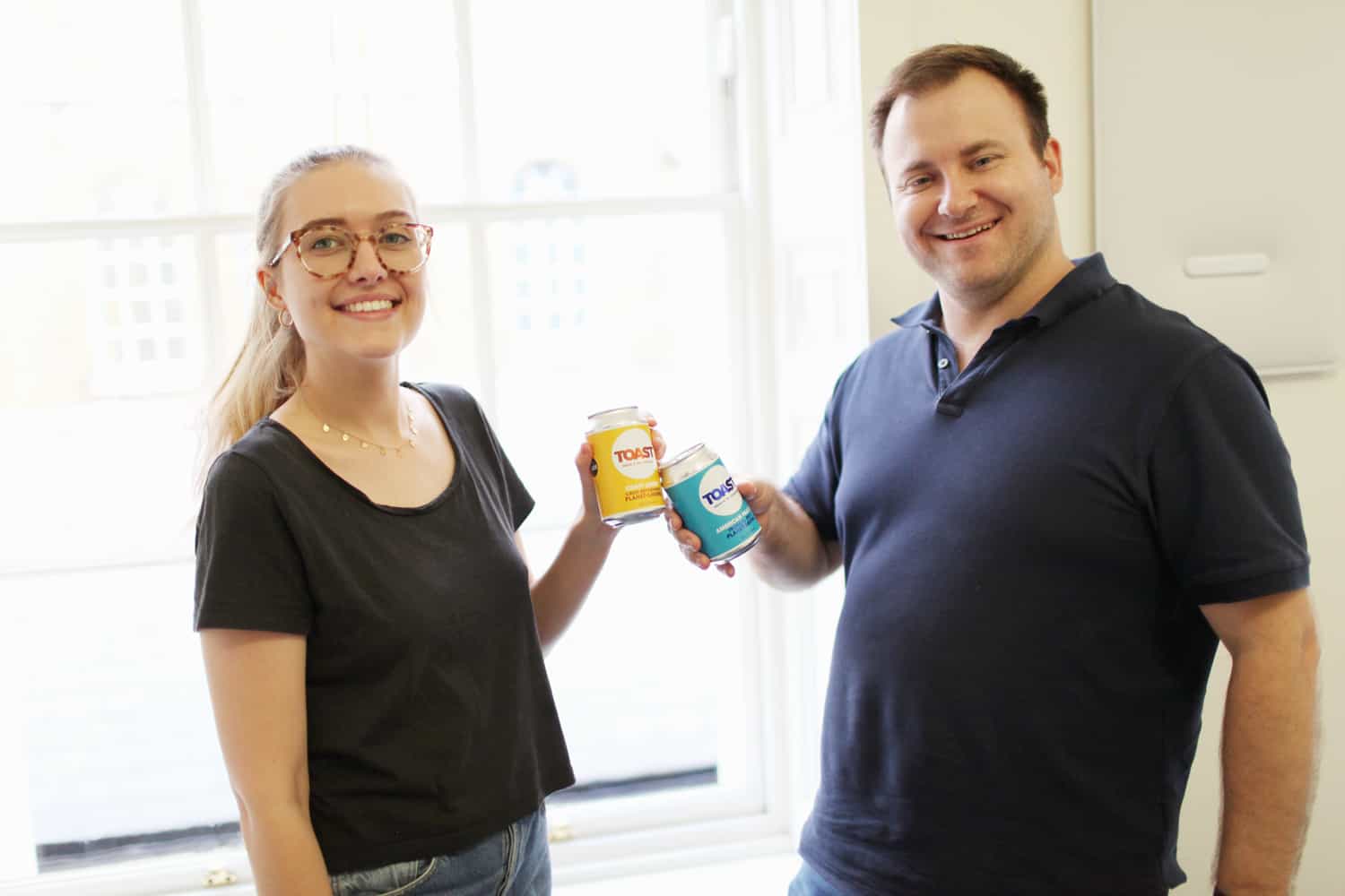 image of tyron and caoilainn from wholegrain holding toast ale